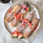 french toast on a white plate with strawberries