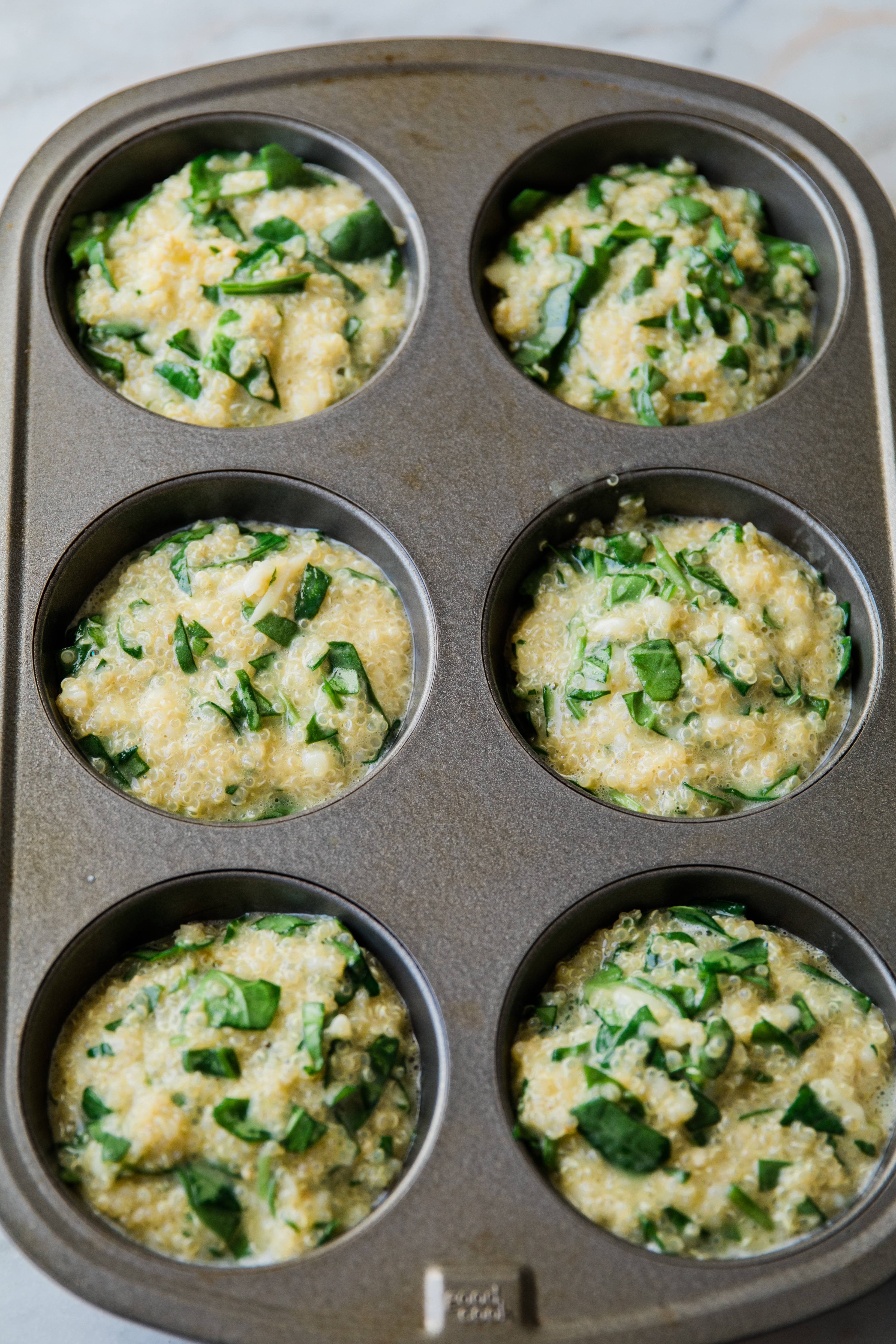 eggs and quinoa in a muffin tin