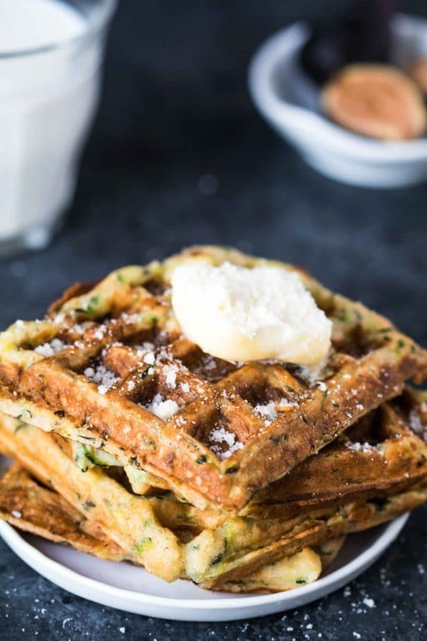 zucchini waffles on a plate topped with butter