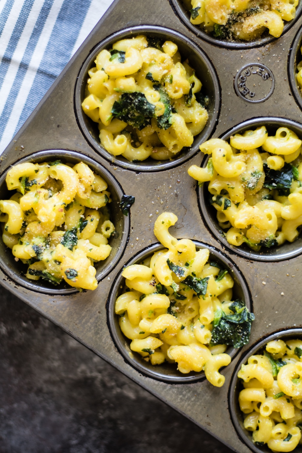 Macaroni and cheese with spinach in cupcake tins for individual portions