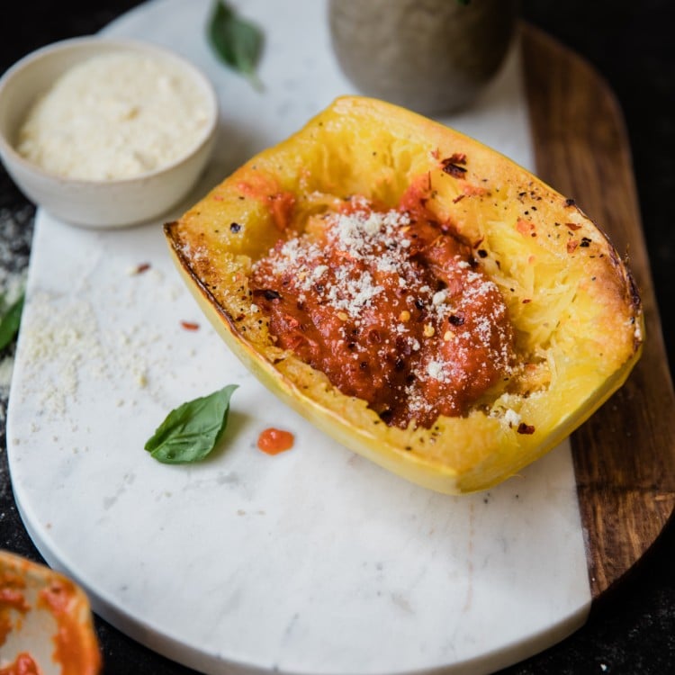 a cooked spaghetti squash on a marble board
