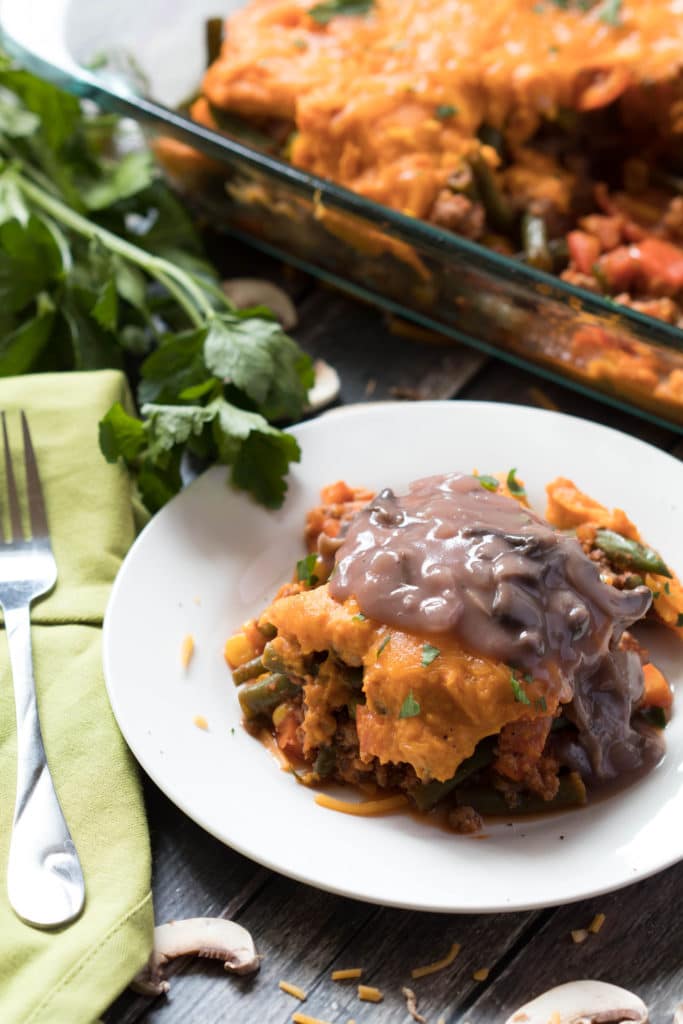 shepherds pie on a white plate with mushroom gravy