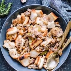 Thanksgiving stuffing in a bowl with gold spoons