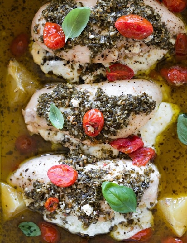 chicken topped with pesto in a baking dish