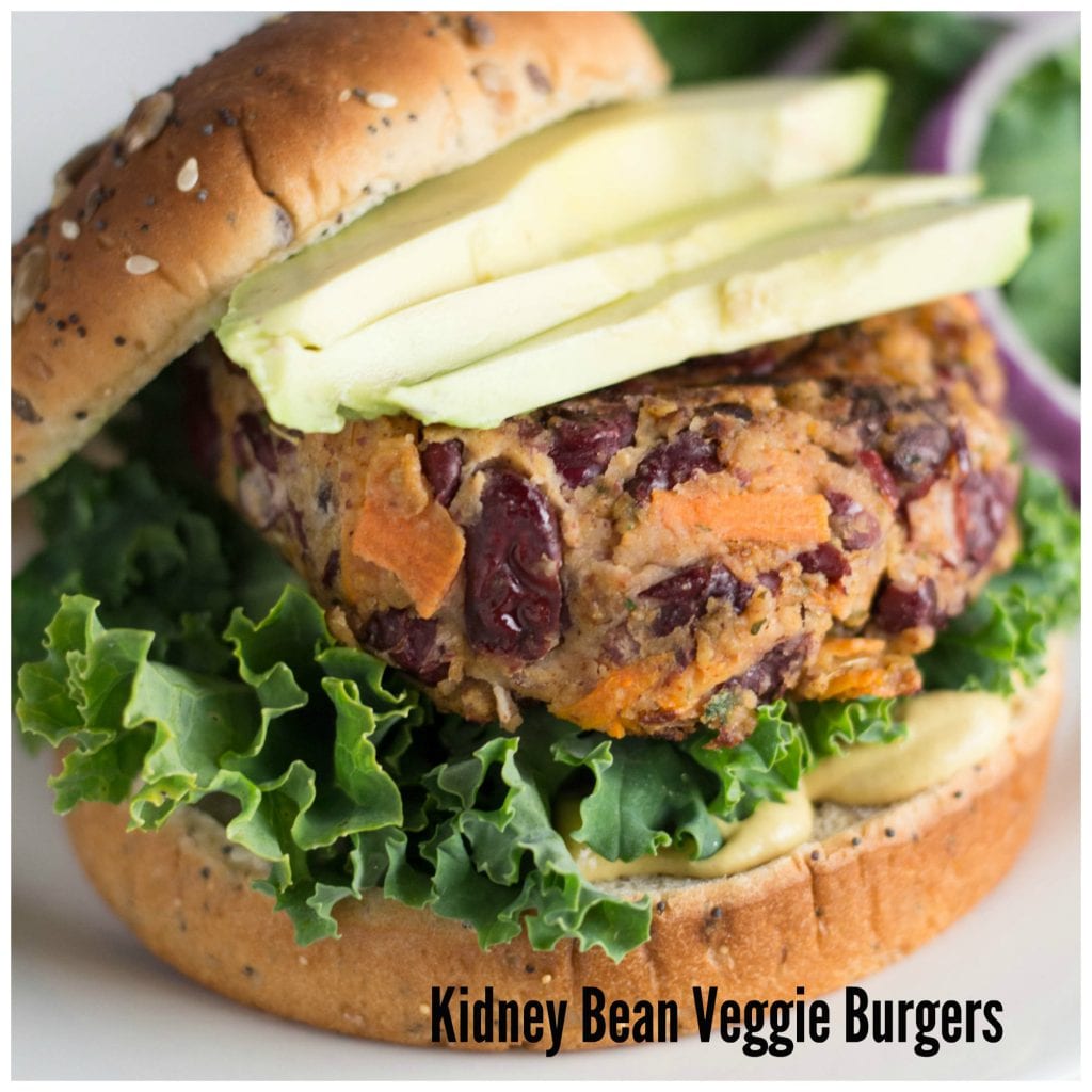 kidney bean veggie burgers on a plate topped with avocado