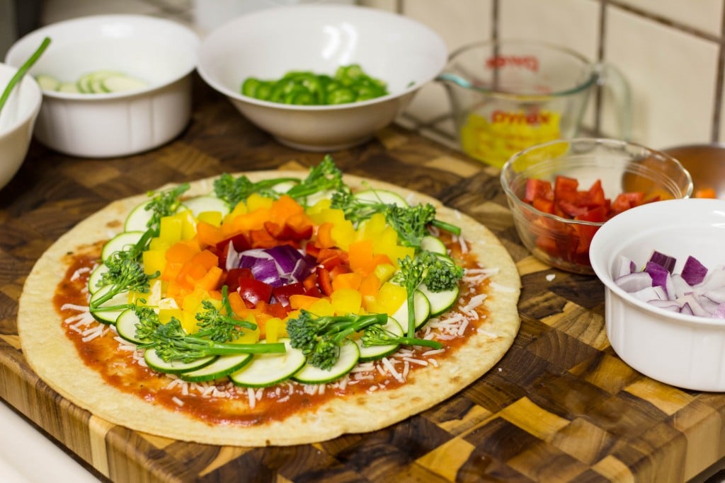 a pizza made with rainbow colored veggies