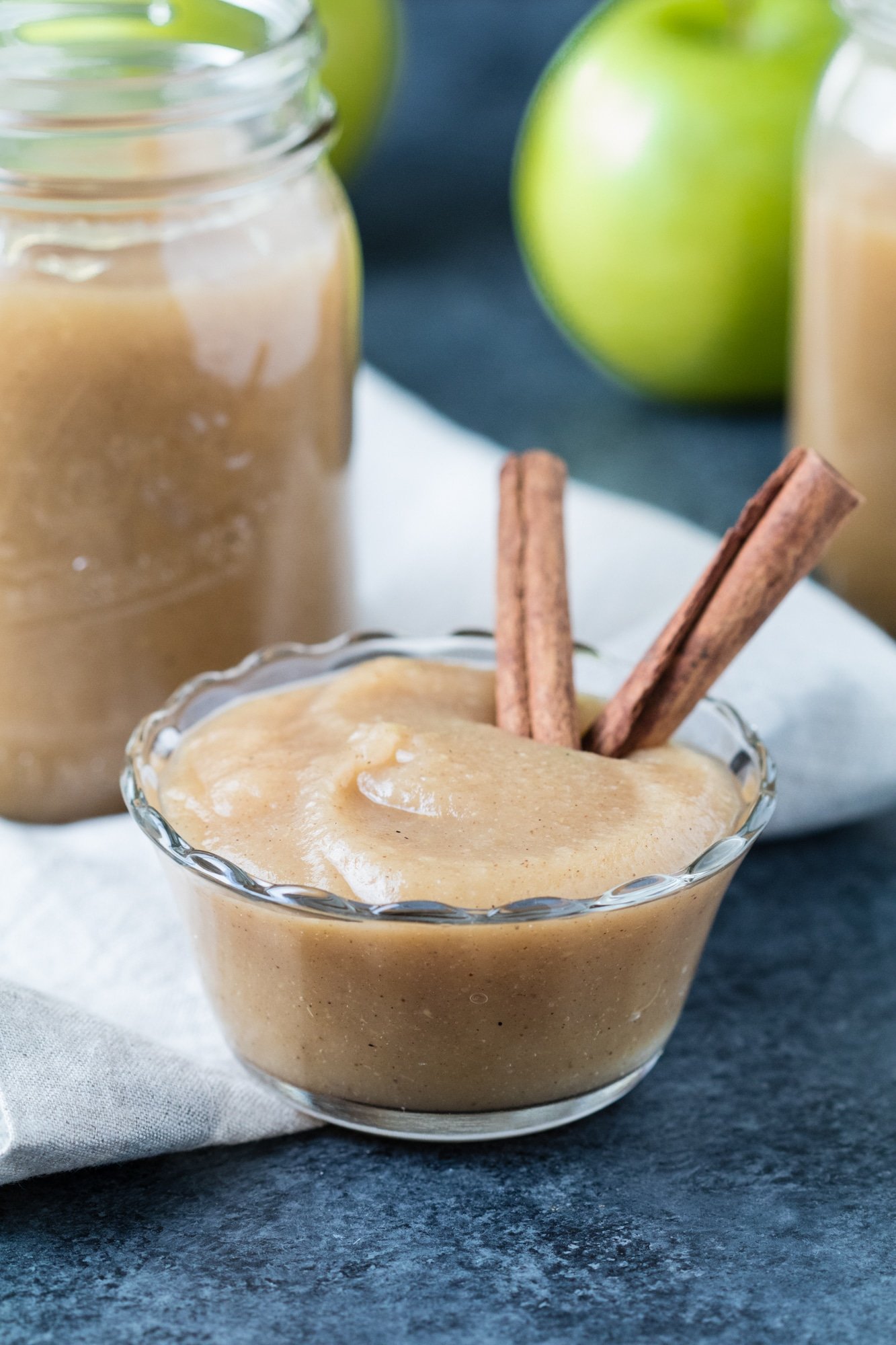 homemade applesauce recipe in glass bowl with cinnamon sticks