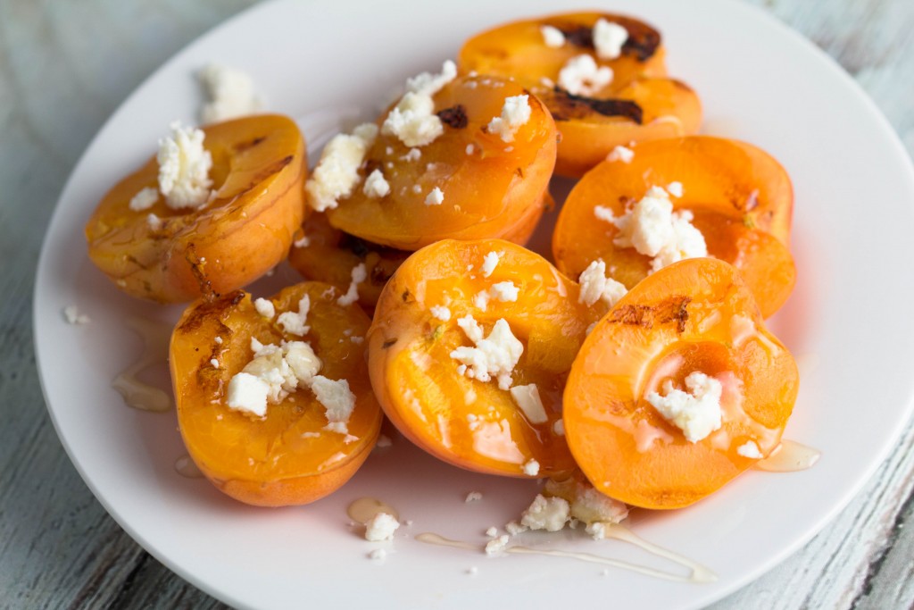 grilled apricots on a white plate