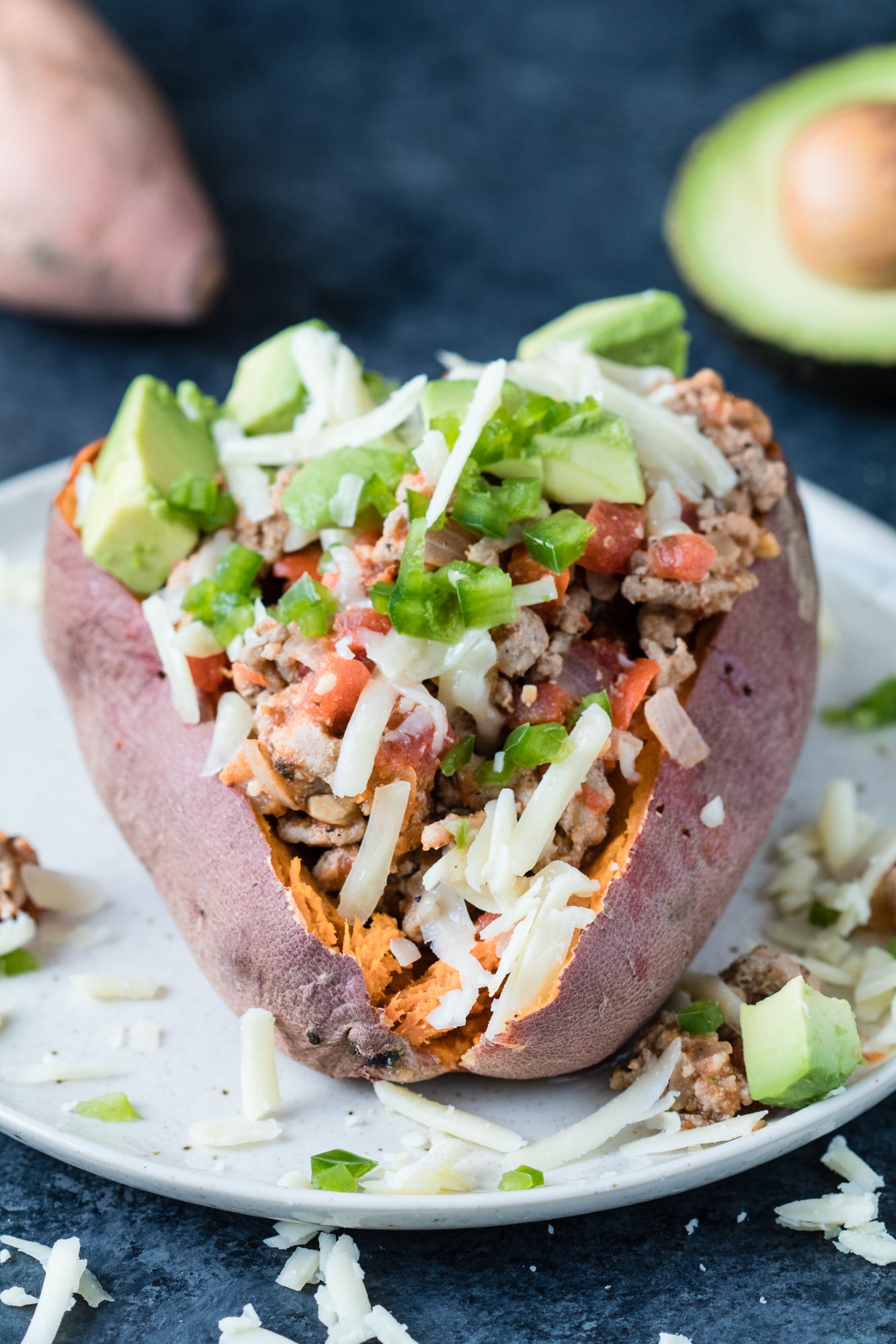 ground turkey with tomatoes and bell peppers and spices stuffed in a sweet potato