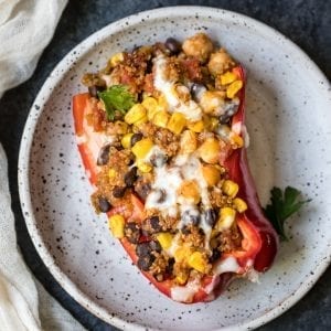 quinoa and veggies stuffed in a red bell pepper
