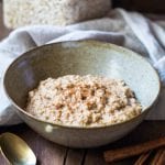 Oatmeal in a bowl on a wooden board