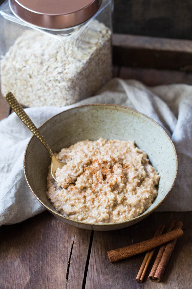 snickerdoodle oatmeal in a bowl topped with cinnamon