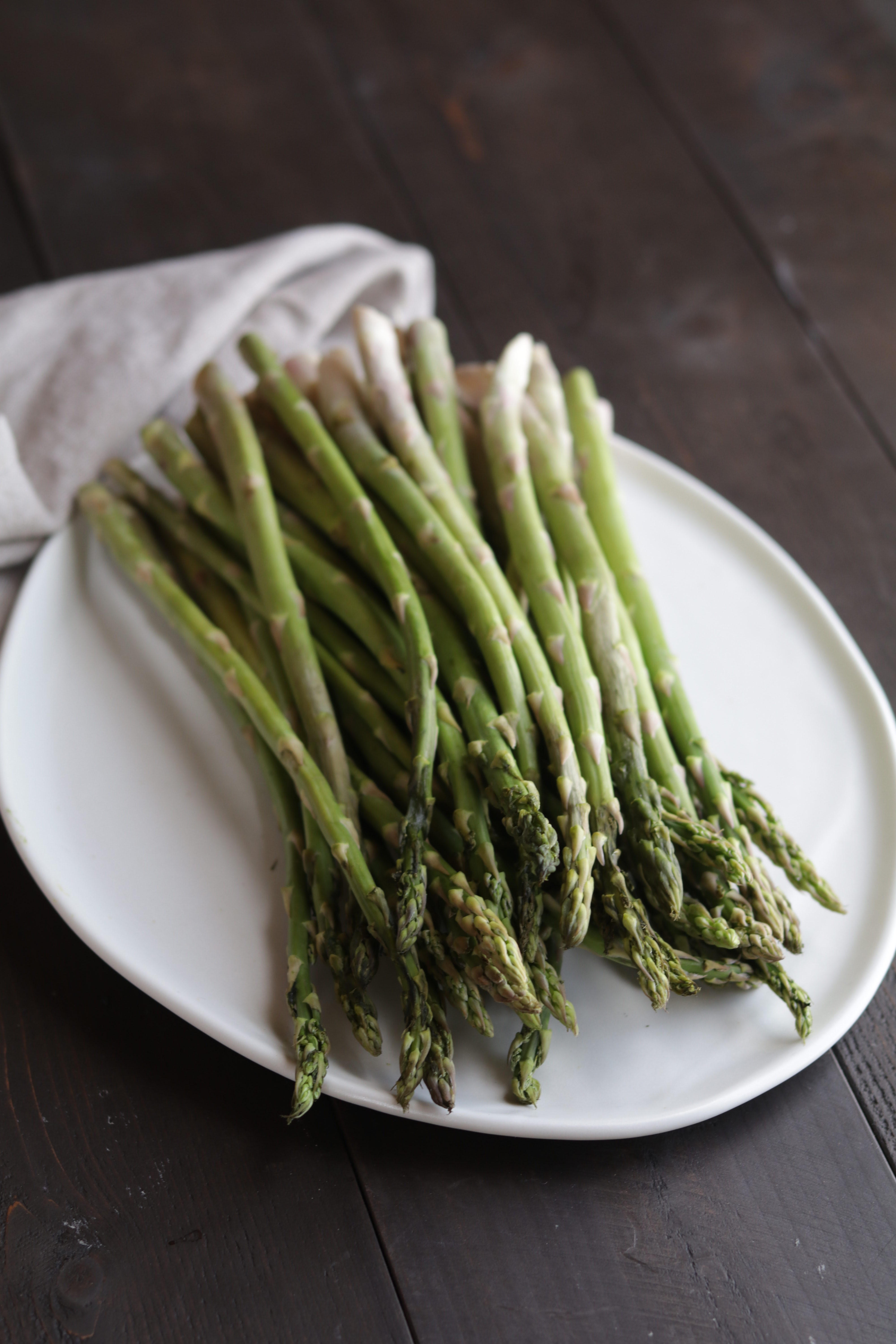 a white plate with asparagus on it