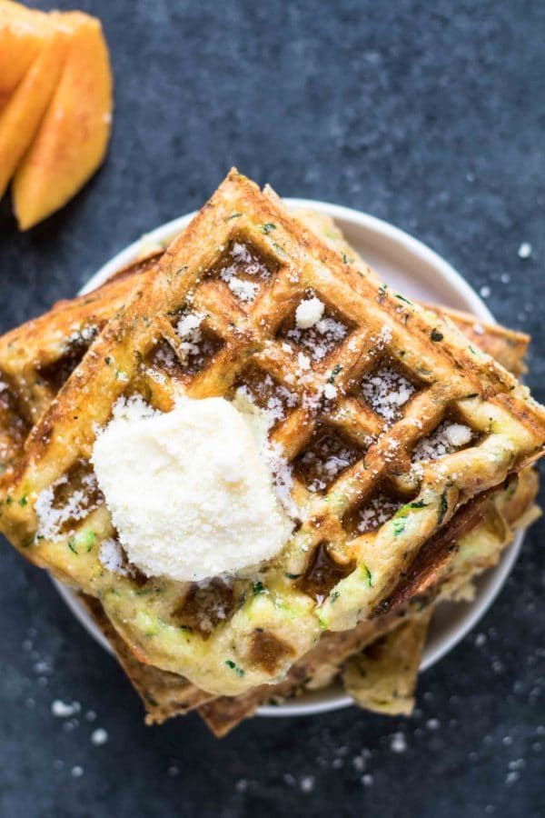 zucchini waffles on a plate topped with butter