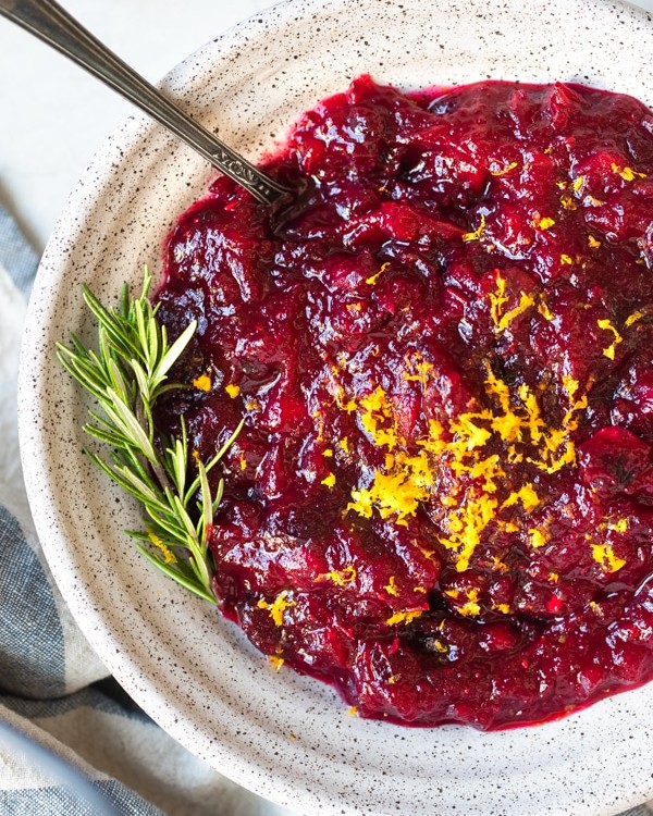 cranberry sauce in a bowl topped with orange zest