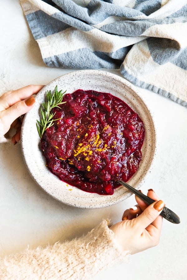 cranberry sauce in a bowl topped with orange zest