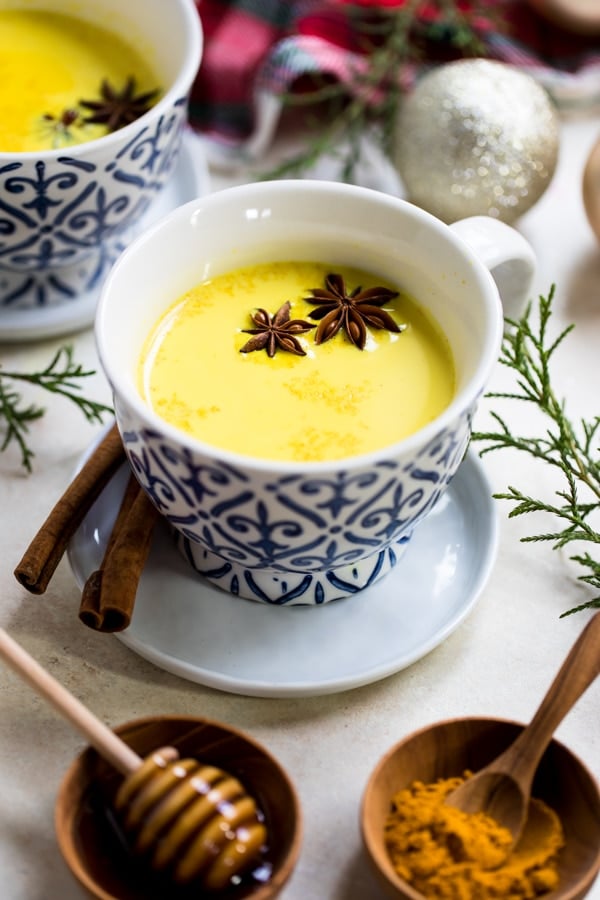 turmeric milk in a mug with star anise and cinnamon