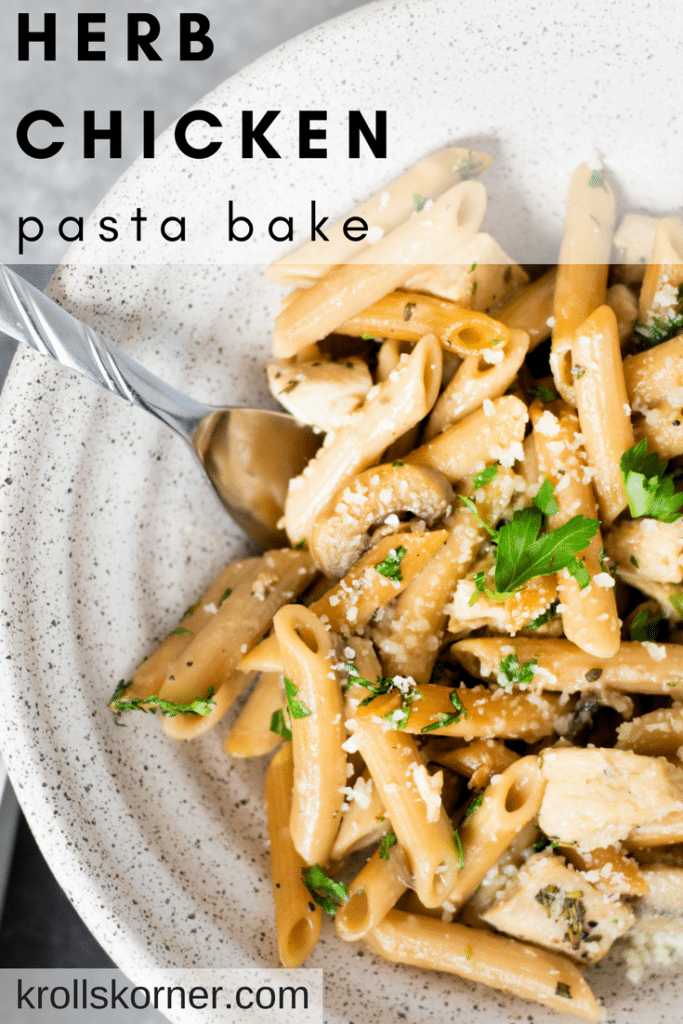 herb pasta in a bowl with chicken and topped with parsley