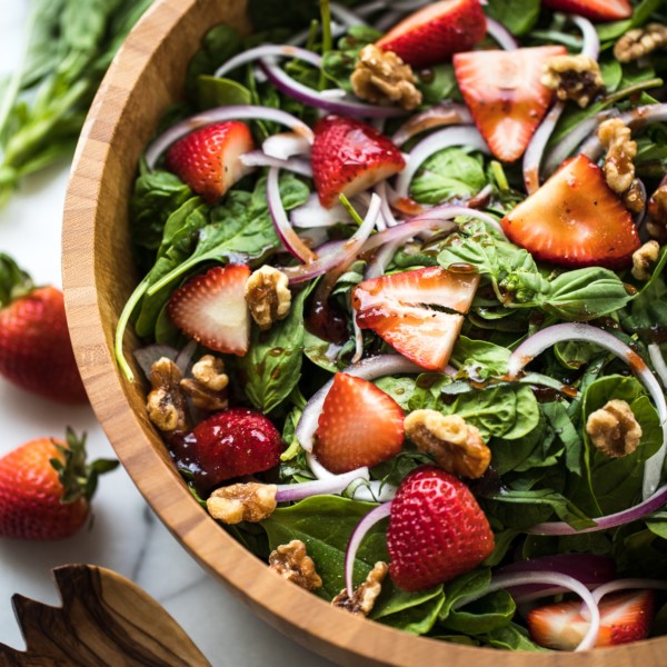 spinach in a wood bowl with stawberries