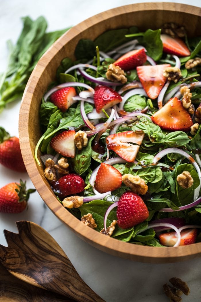 spinach in a wood bowl with stawberries