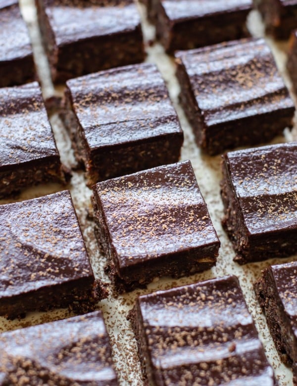 brownies on parchment paper dusted with cocoa powder