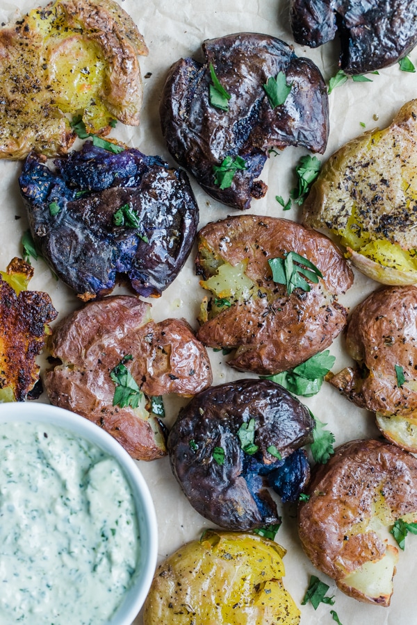 smashed baby potatoes on parchment paper