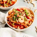 noodles in a white bowl with peanut sauce and shrimp