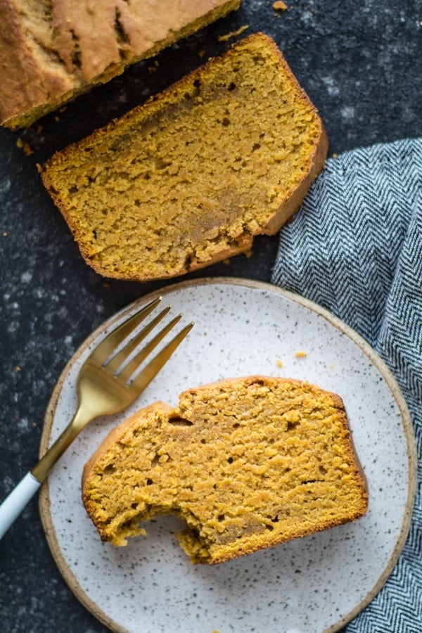 Pound cake on a plate with a fork and a napkin