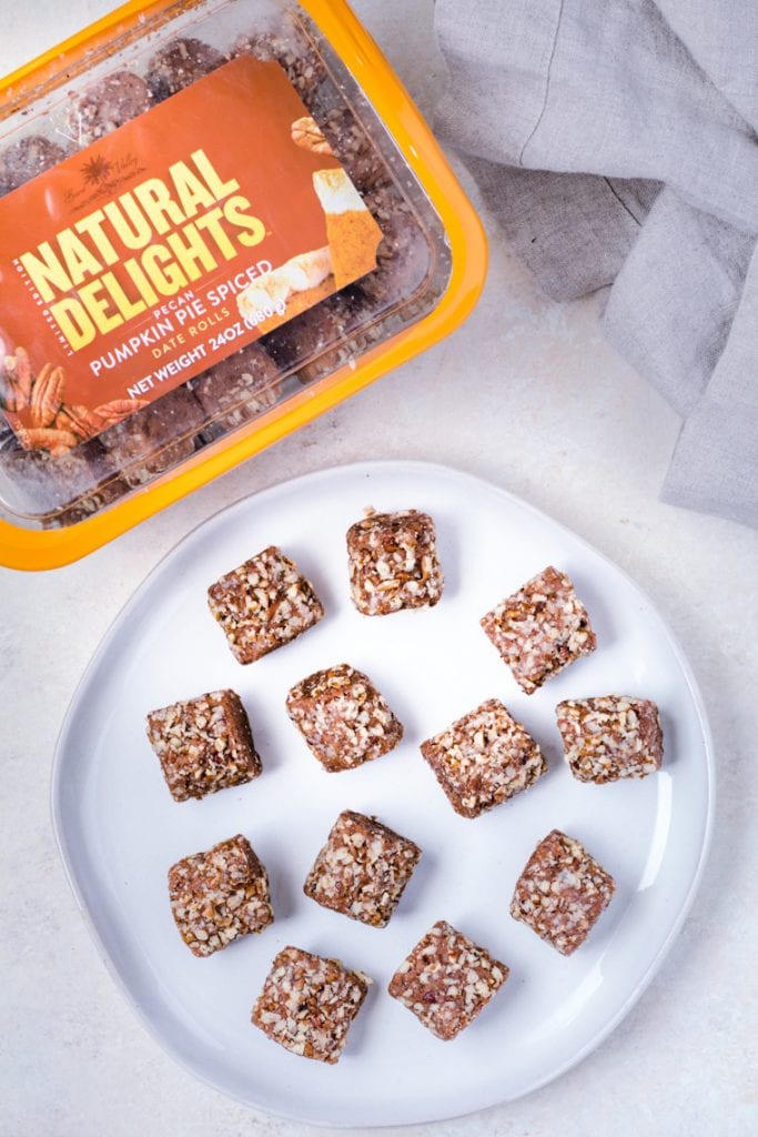 Natural Delights® Pecan Pumpkin Pie Spice Date Rolls on a white plate.