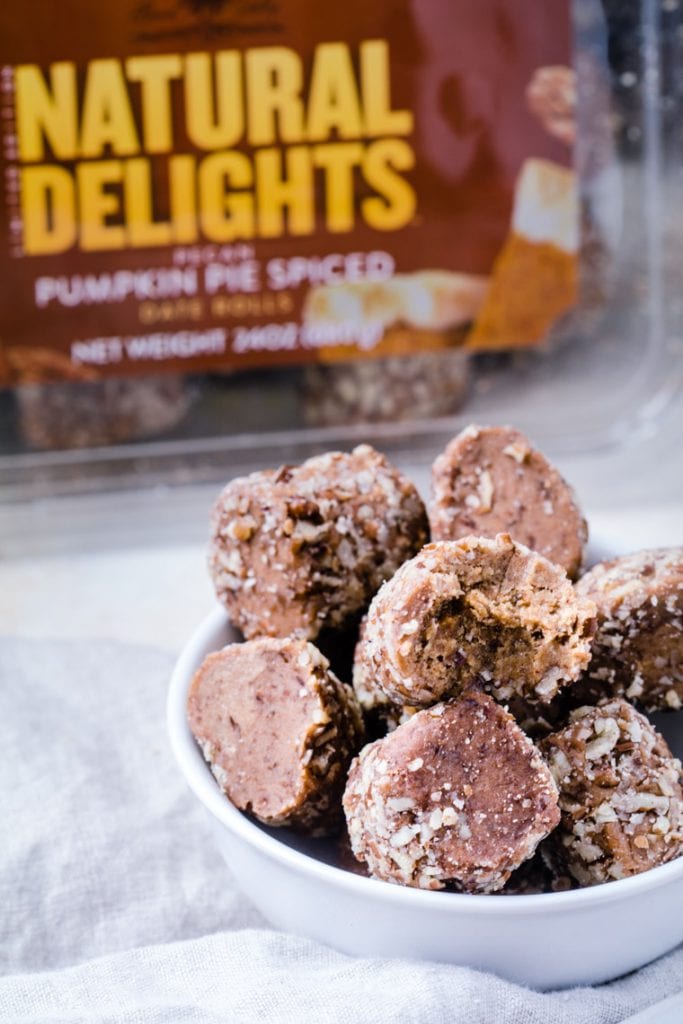 Natural Delights® Pecan Pumpkin Pie Spice Date Rolls in a white bowl on a napkin.