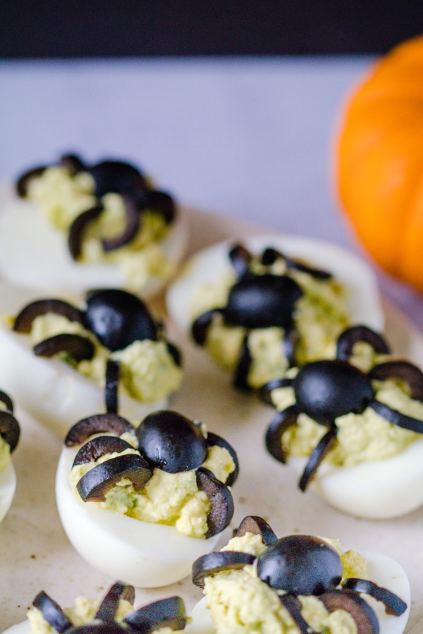 Halloween Deviled Eggs on a cream colored plate.