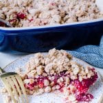 Cranberry oat crumble on a plate with a gold fork