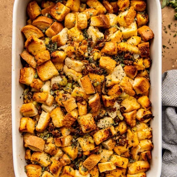 overhead shot of sausage mushroom stuffing in a white casserole dish