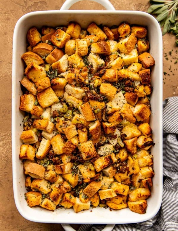 overhead shot of sausage mushroom stuffing in a white casserole dish