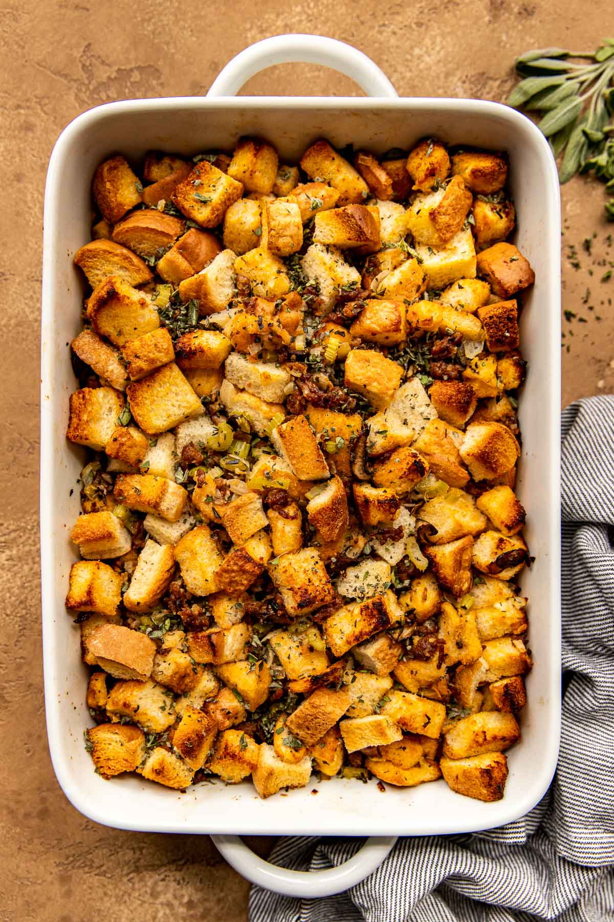 overhead shot of sausage mushroom stuffing in a white casserole dish