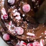 chocolate bundt cake with chocolate frosting and sugared cranberries