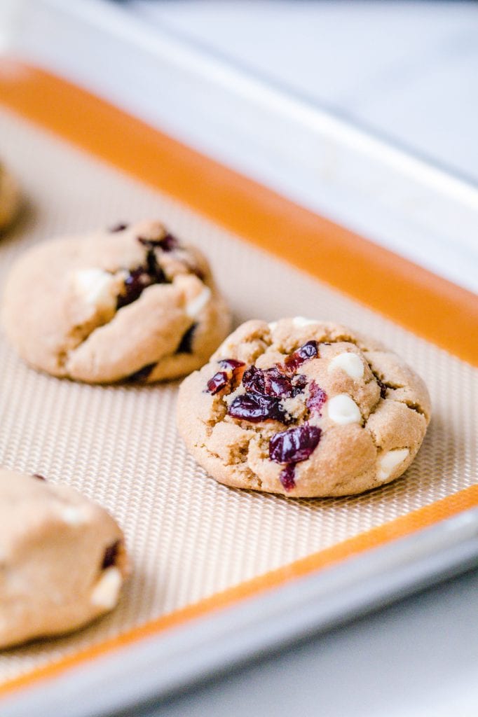 White chocolate cranberry cookies on a marble slab