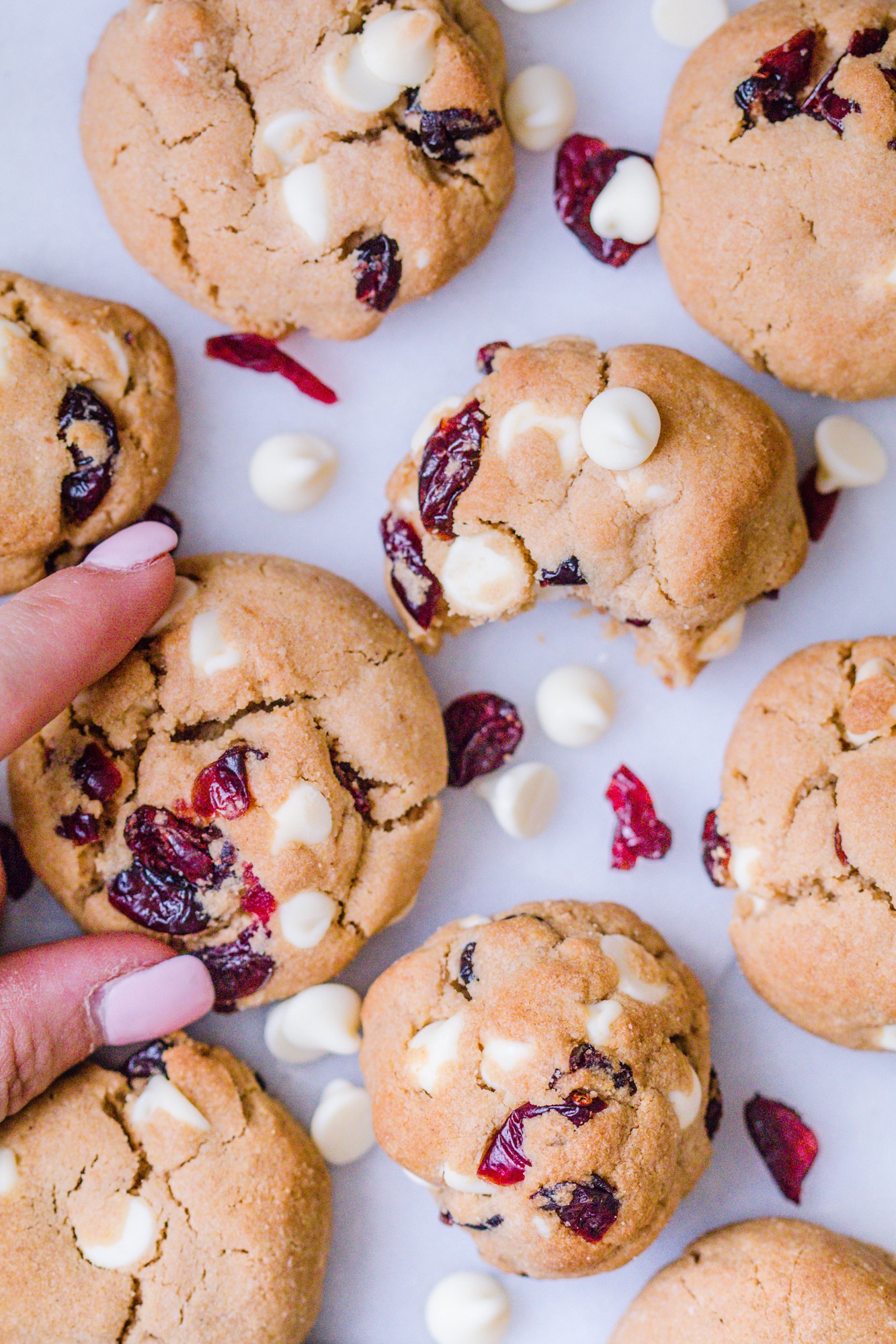 White chocolate cranberry cookies on a marble slab