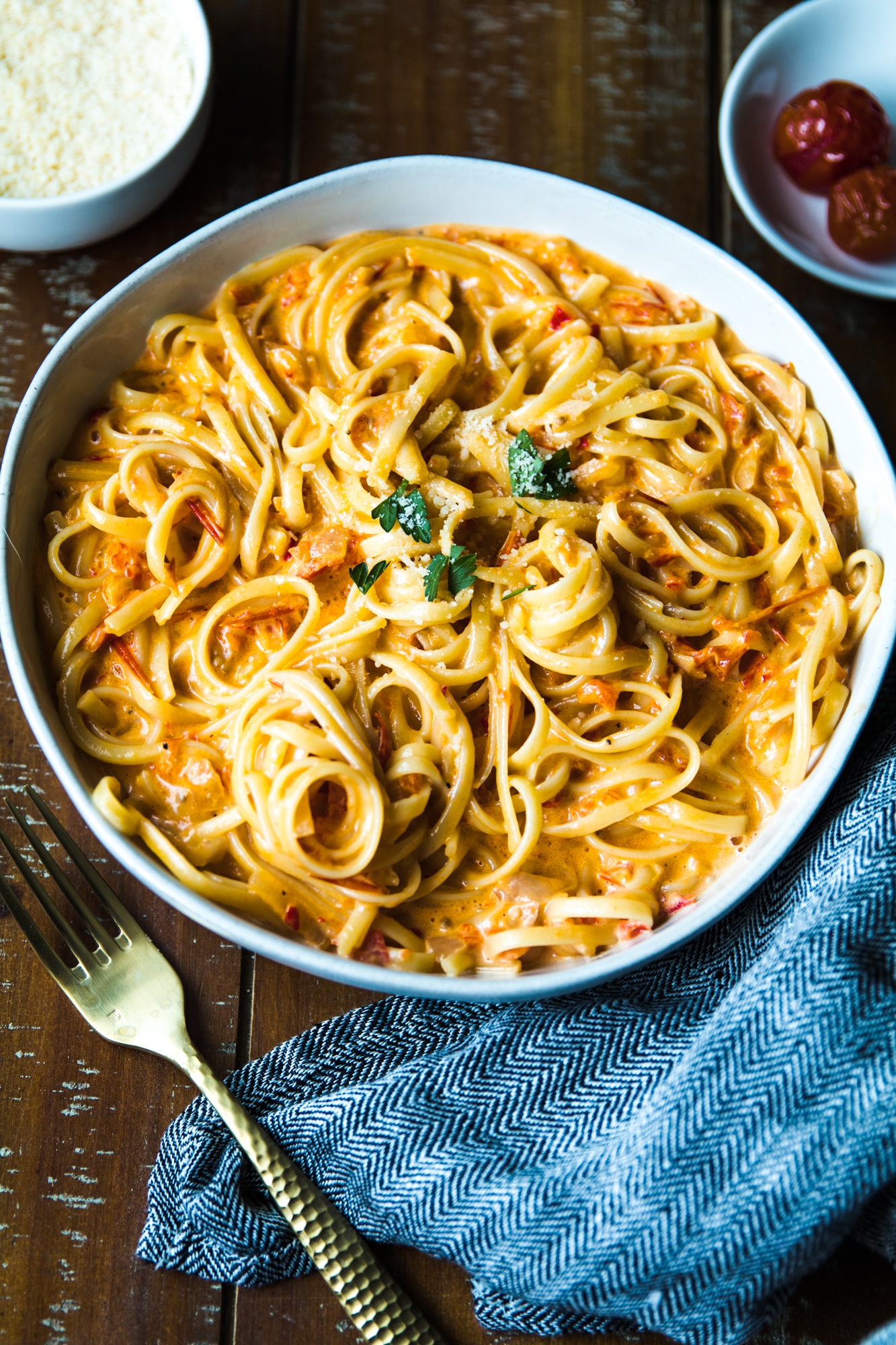 Pasta with tomatoes and bell peppers in a white bowl