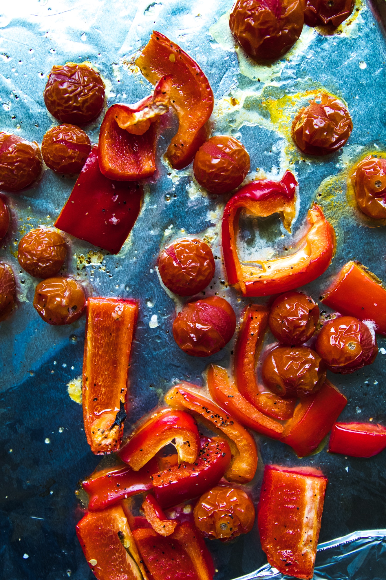 roasted bell peppers and tomatoes on a sheet pan