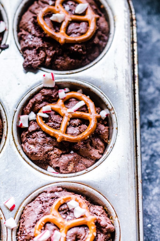 A brownie bite on a plate with melted chocolate