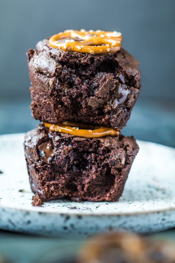 A brownie bite on a plate with melted chocolate