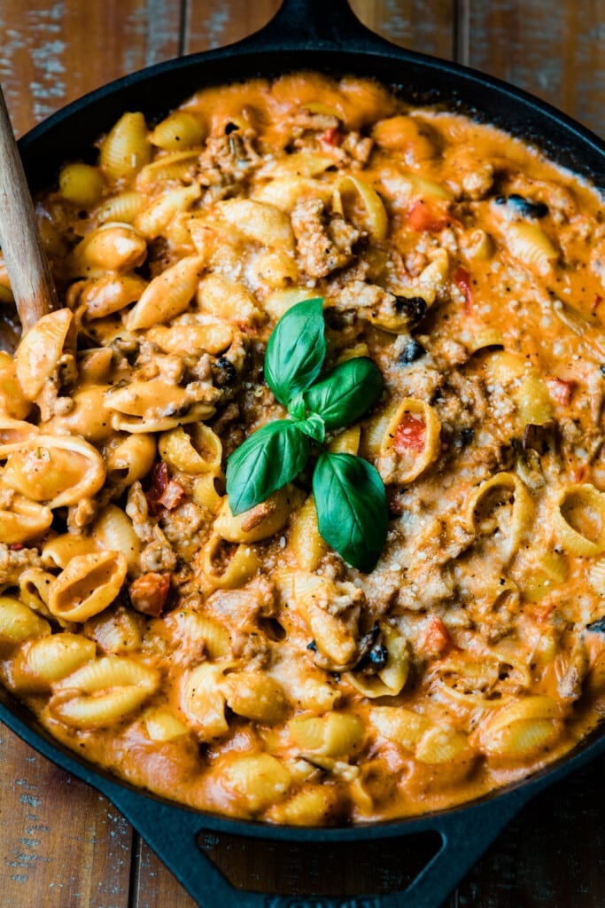 ground turkey pasta in skillet with wooden spoon