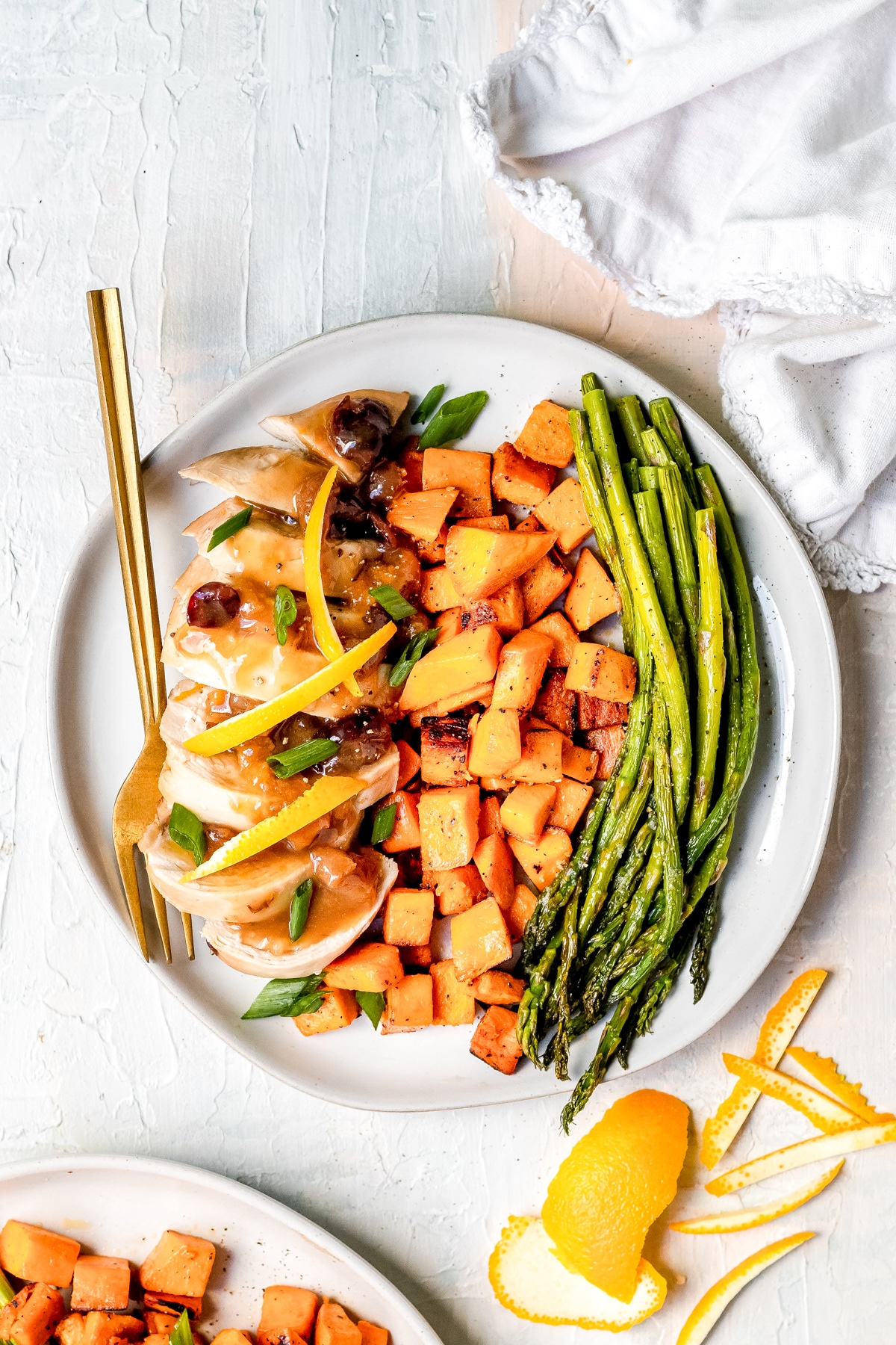 chicken breast made with dried cranberries and dried apricots on a white plate