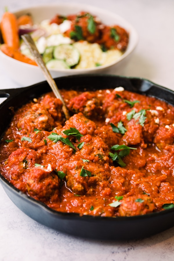 harissa meatballs in a cast iron skilelt