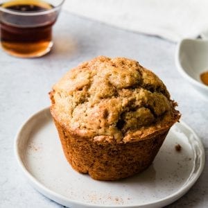 A snickerdoodle muffin on a white plate
