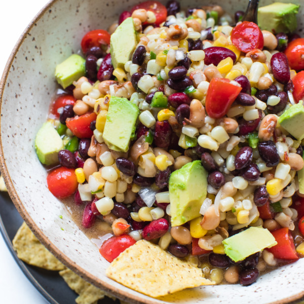 texas caviar in a bowl topped with avocado