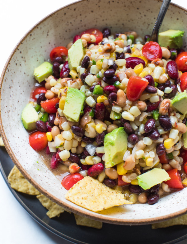 texas caviar in a bowl topped with avocado