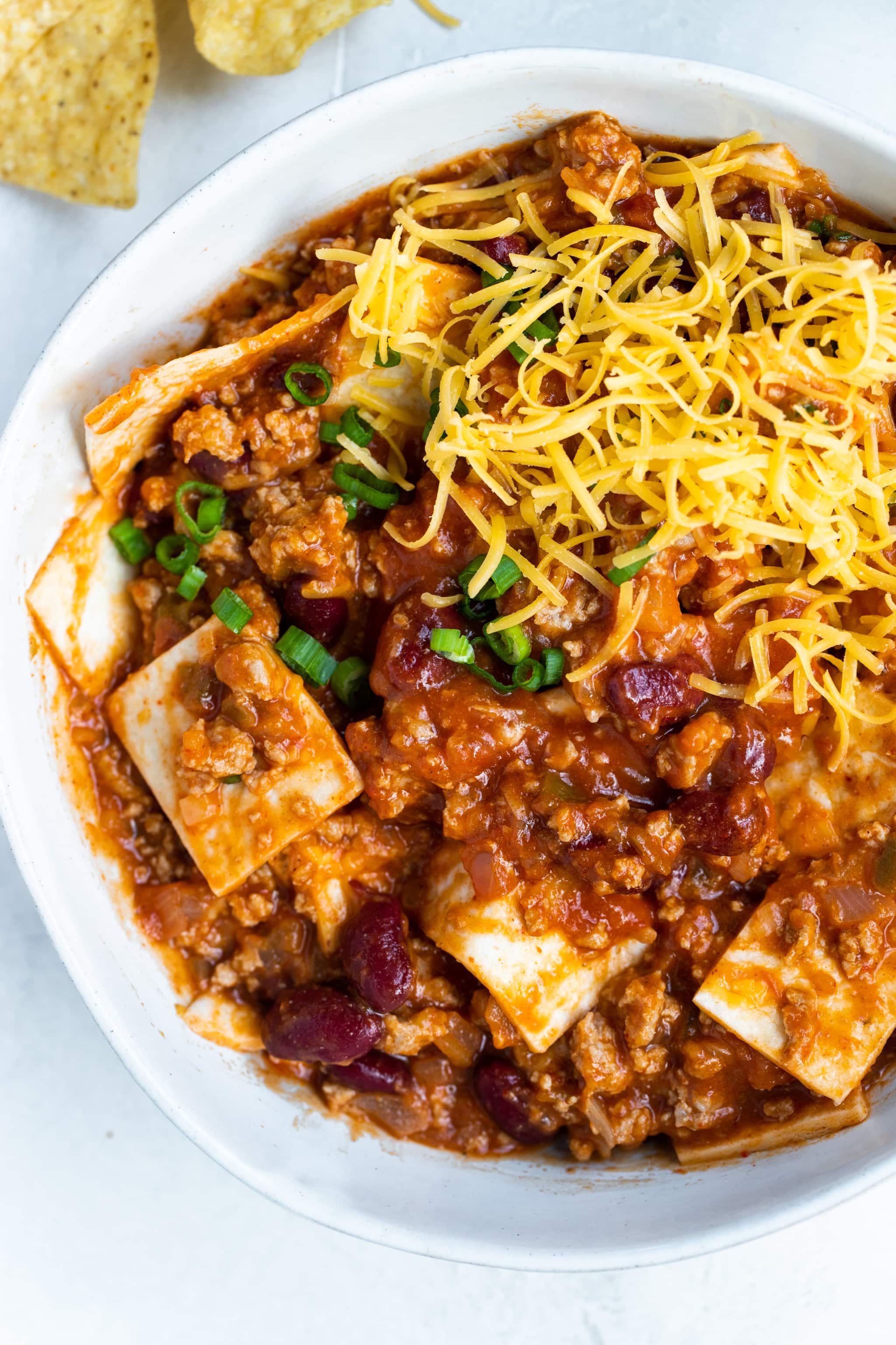 taco skillet in a white bowl topped with cheese