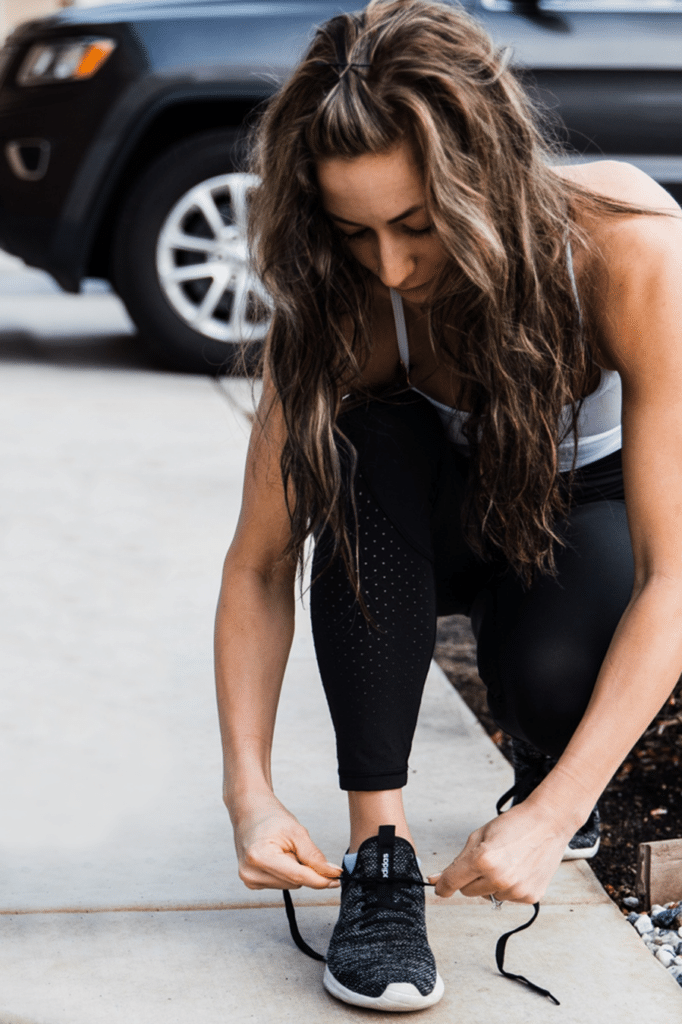 A woman tying her shoes